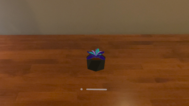 &ldquo;A black pot containing a plant with blue and green leaves with a purple stem.&rdquo;